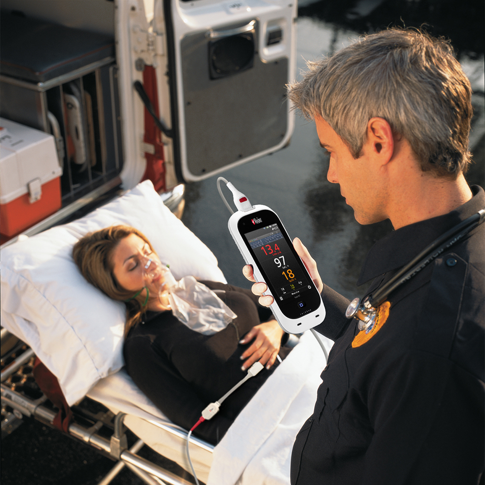 EMT monitoring patient using a Masimo device.